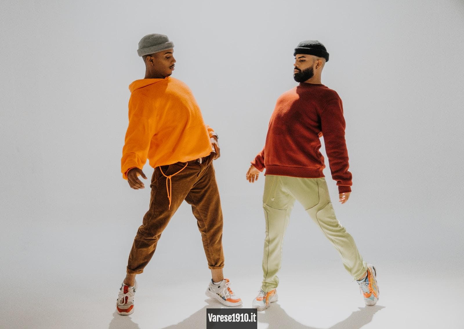 man in orange long sleeve shirt and white pants