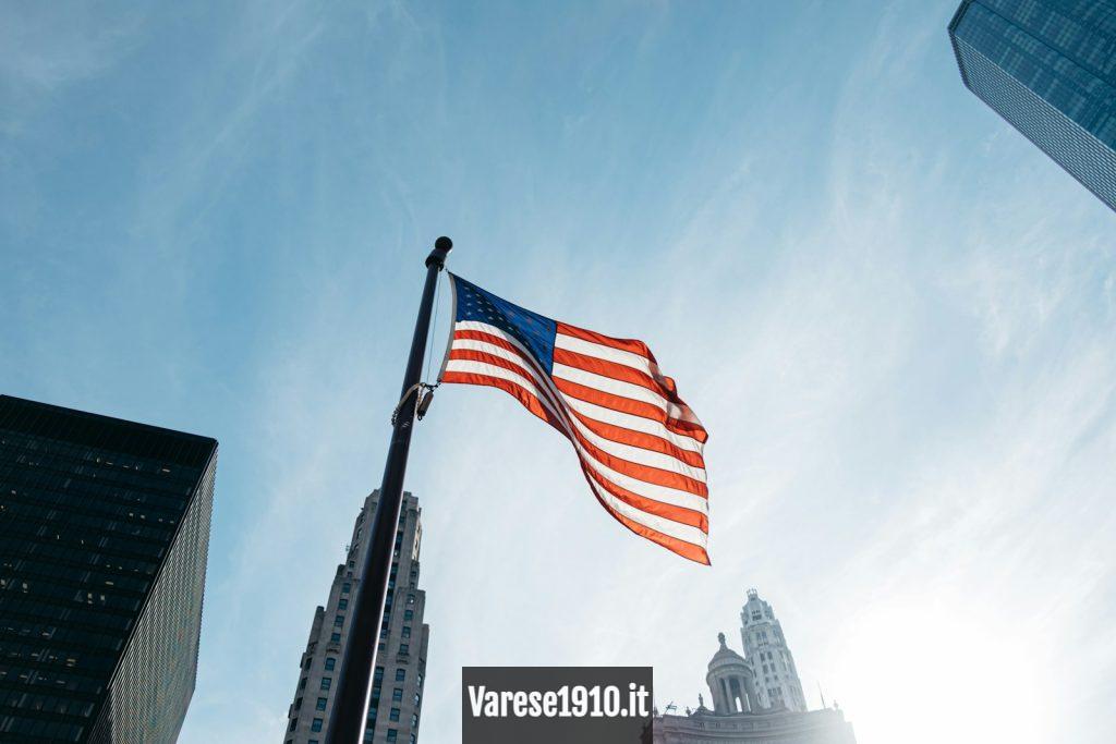 USA flag on pole at the city during day