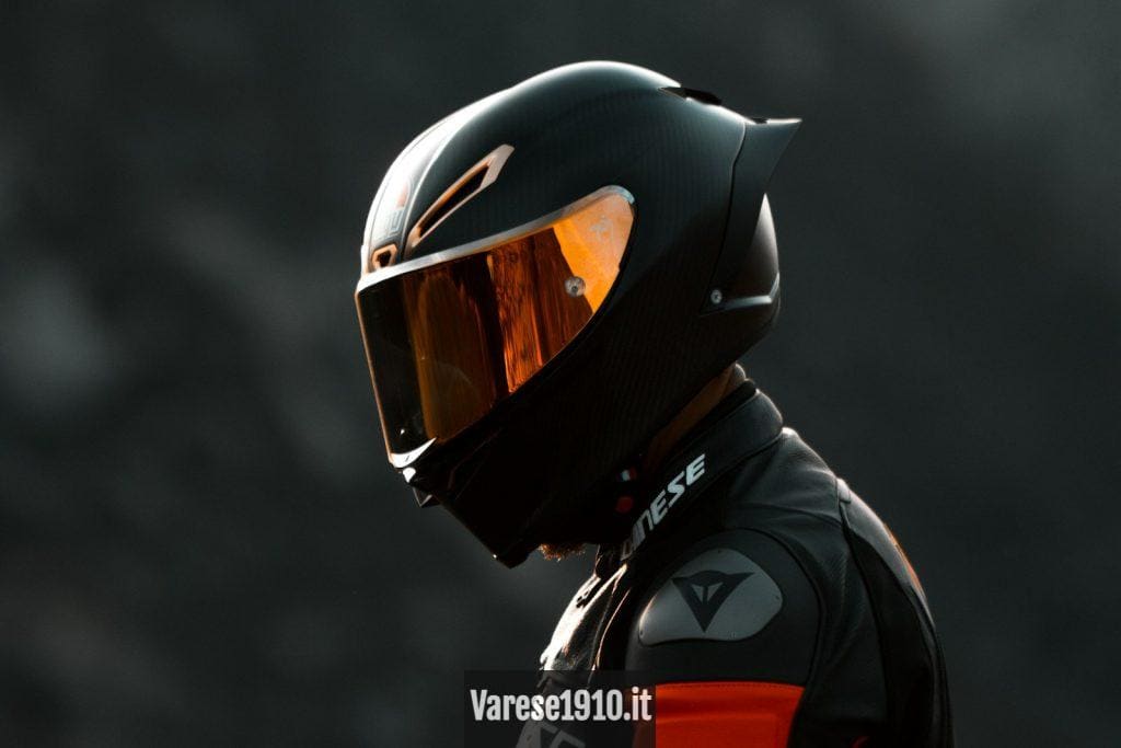 black and orange helmet on black motorcycle